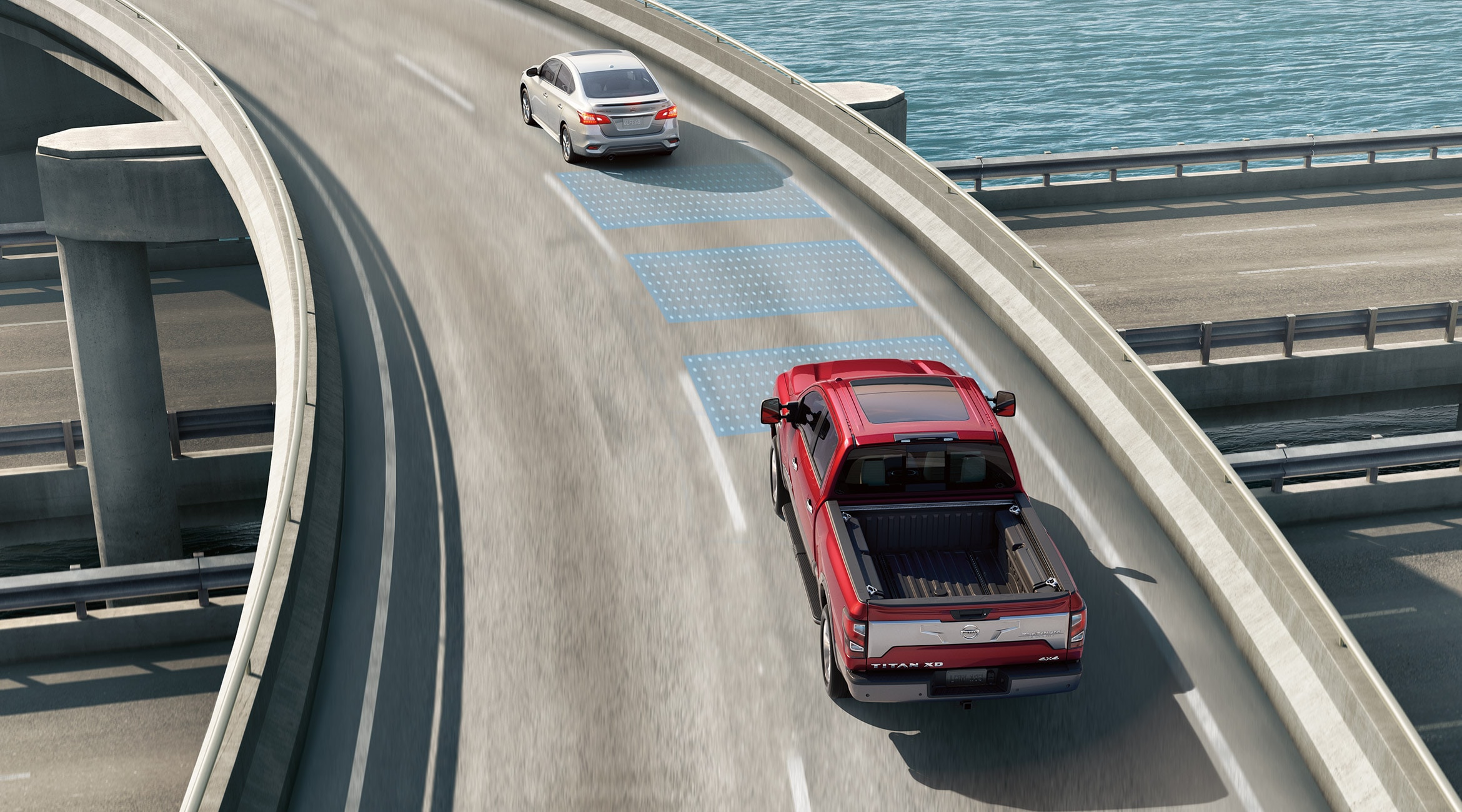 Un Nissan Titan XD rouge roulant sur une autoroute alors que le système de détection de sortie de voie est actif